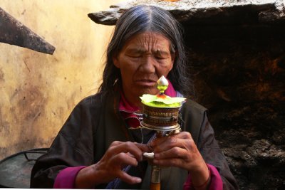 Woman with prayer wheel