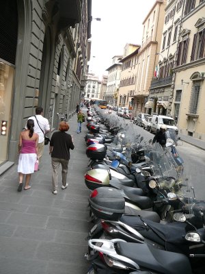 long row of scooters stretches the entire block (R)