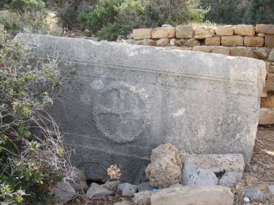 This is a sarcophagus near the church with the carving of a cross.