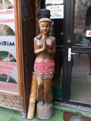 Wooden Indian in front of an antique store.