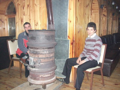 Warming up around the pot belly stove in the restaurant.  It looked like it was made from tire rims.