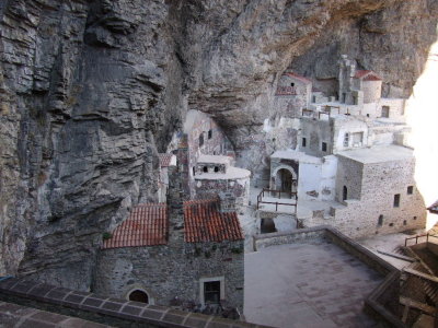Monastery buildings under the overhang of the cliff.