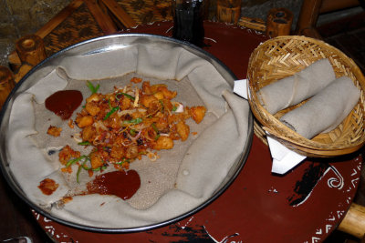 food ordered by neighbour table; injera and fried fish fillet, looks good