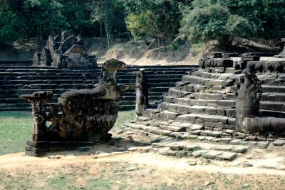 the circular island in the middle is encircled at its base be 2 naga serpents, their heads on its E and tails entwined on the W