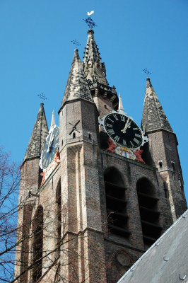The brick spire with the four angle towers is reminiscent of Flemish architecture.