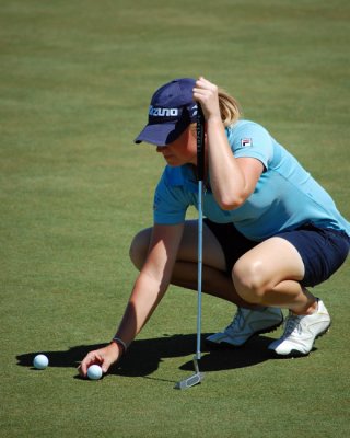Stacy lines up a putt