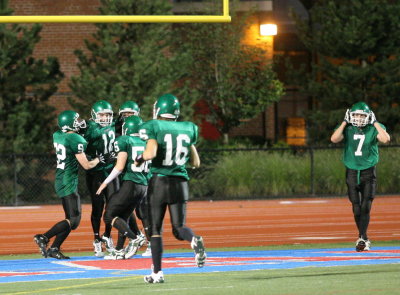 Some happy football players in the end zone