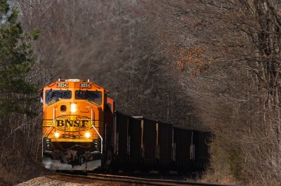 NS train 232 works hard to pull a heavy coal train up a grade between Moscow and La Grange