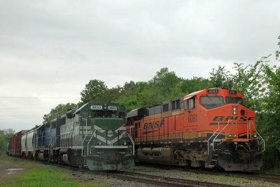 A pair of DPU on the BNSF train passes parked EVWR power. The heavy rain made for lens spots unfortunately.