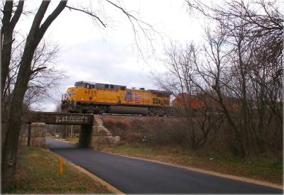 UP Engine 6035 leads a consist of BNSF engines over the crumbling Chase road bridge.jpg