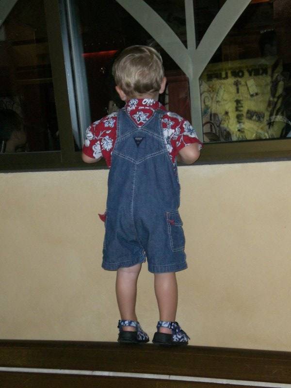 Jake waiting for our table at Cheesecake Factory, Waikiki