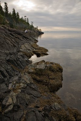 DJ on the rocks below their cabin