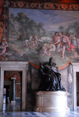 Bronze statue of Pope Innocent X in front of the fresco Ritrovamento della Lupa (1595-6) by Cavaliere d'Arpino