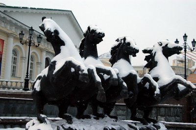 Snow covered horse fountain in front of the Moscow Manege, a former indoor riding academy built 1817-1825