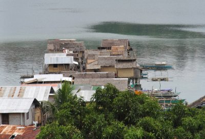 Many houses are built on stilts over the water of the sheltered cove on the south side of Culion Town