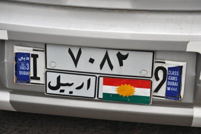 Car with Kurdish flag pasted over the name Iraq
