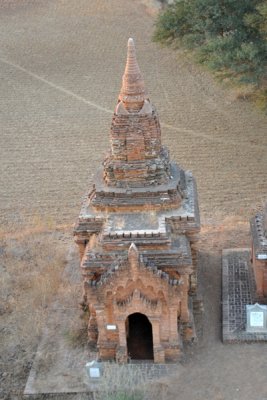 Small temple on the edge of a plowed field