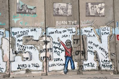 West Bank Separation Wall graffiti - Palestinian youth giving V sign