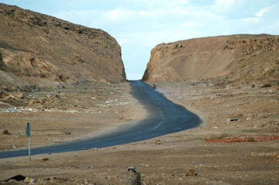 Desert road cut through a bluff