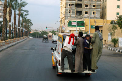 Riding the back of a truck, Aswan