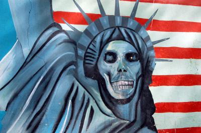 Famous mural of Statue of Liberty with a skull face in front of an American flag, former US Embassy, Tehran