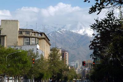 Ferdosi Street with a view of the cloud and snow covered Alborz Mountains