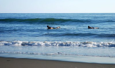 1 of 4: Surfers waiting for the right wave