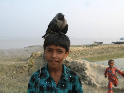 Boy with a nasty old crow on his head!