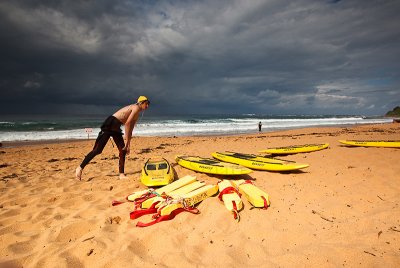 Surf life saver at Newport Beach with approaching storm