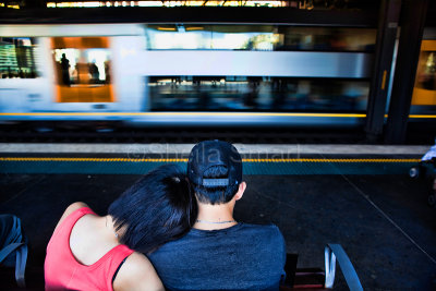Couple on seat in railway station