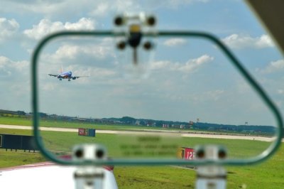 Holding short of 15R we watch an airliner approach for a landing at San Antonio Airport.