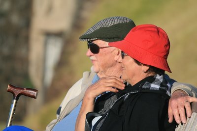 Elderly couple enjoying watching the man flying..
