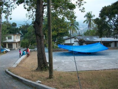 people living under the tarp on the basket ball court