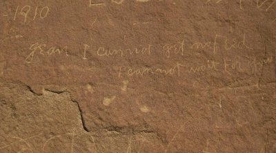 Melancholy note on sandstone wall in Chaco Canyon
