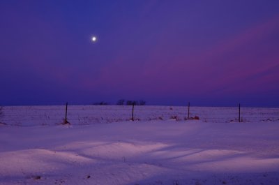 Waning Gibbous Moon over Snow Landscape
