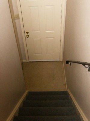 Looking down stairs (front door/foyer/coat closet)