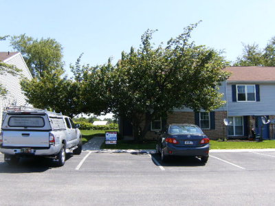 Front of condo (end unit - behind tree)
