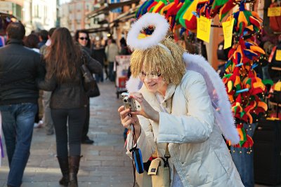 An angel taking pictures of humans