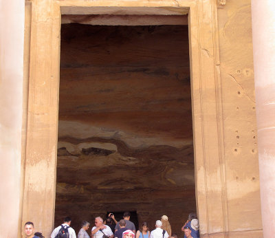 At the huge doorway, a glimpse of the interior