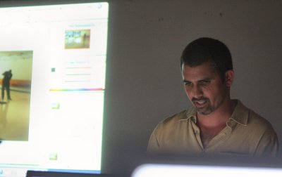 Instructor with slide illustration and glowing LCDs in front