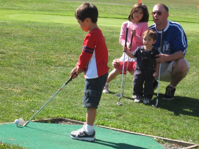 Daddy, Noah, Sarah, and Kyle at the Golf Course
