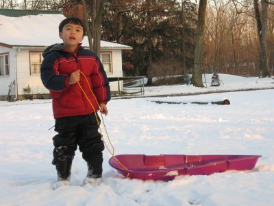 Kyle playing with his sled