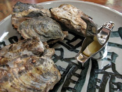 Freshly grilled oysters with lemon
