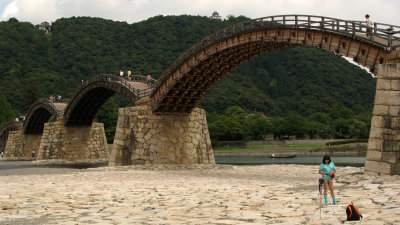 Cross-dressing visitor posing in front of the bridge