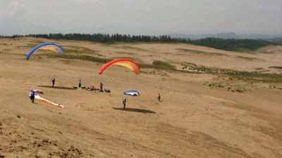 Paragliders trying to catch a breeze