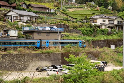 Train passing by a village off Tosa-Iwahara