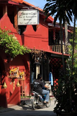 Motorcyclist riding past a boutique restaurant & inn