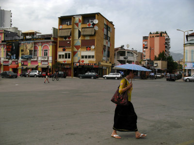 Woman with parasol in central Tirana