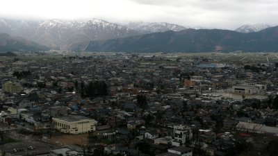 Sprawl of Ōno city and snowcapped mountains