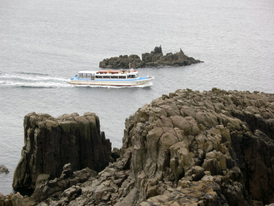 A sightseeing boat passing the rocks